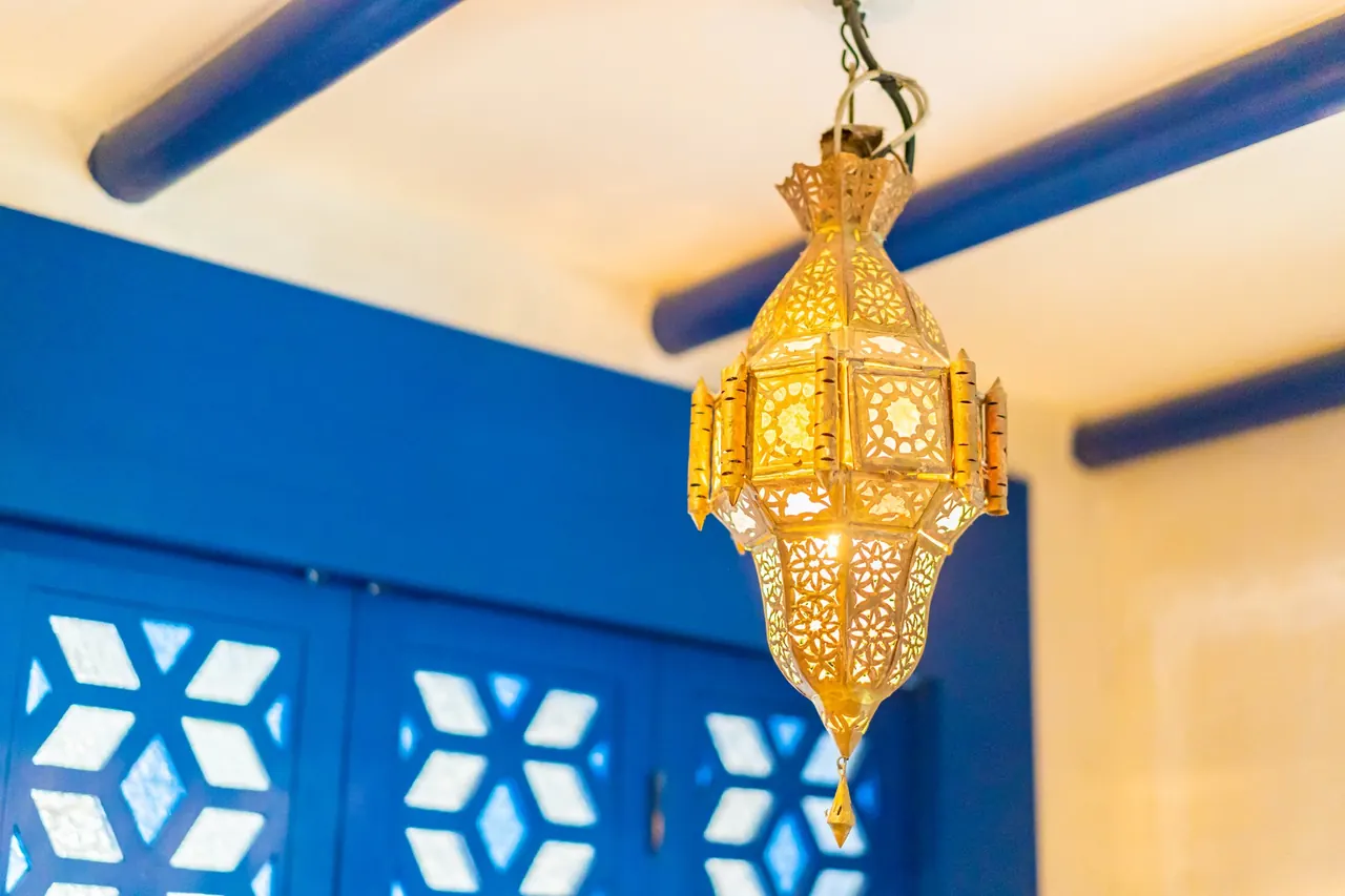 A Moroccan lamp casting patterns on the wall